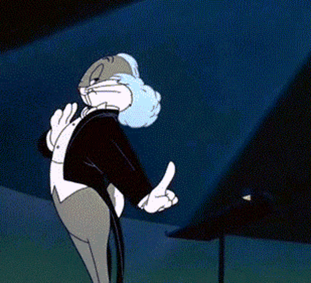 a cartoon character named bugs bunny is wearing a tuxedo and pointing