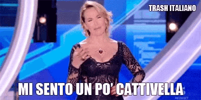 a woman in a black dress is standing in front of a blue background and says trash italiano