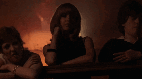 a group of people sitting in a dark room