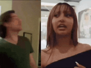 a man and a woman are standing next to each other . the woman is wearing a black off the shoulder top .