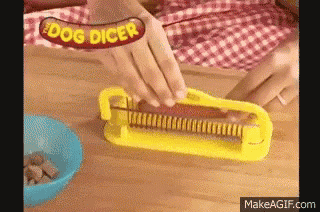 a person is cutting a hot dog with a dog dicer