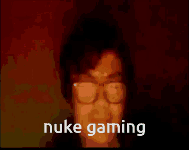 a picture of a man with glasses and the words " nuke gaming "