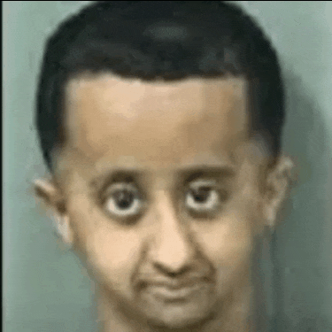 a close up of a man 's face with big eyes and a big head .