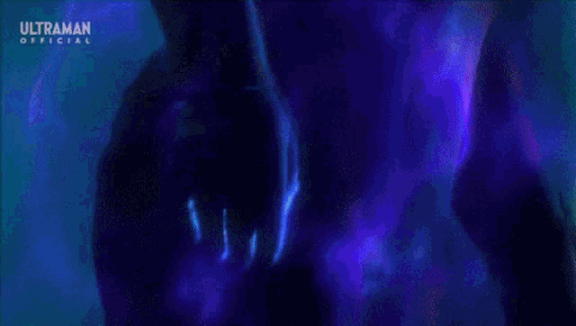 a purple light is coming out of a person 's hand in a dark room .