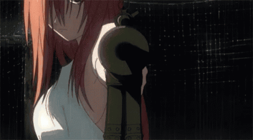 a girl with red hair is holding a fireball in her hand in a dark room .