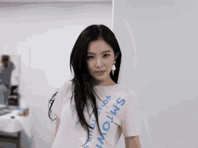 a woman wearing a white t-shirt with smtown on it