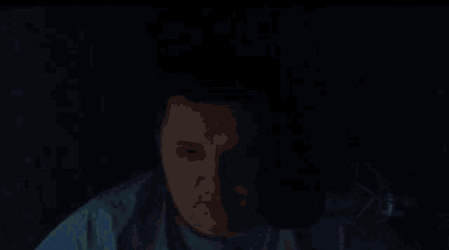 a person wearing headphones with a blue light on their face