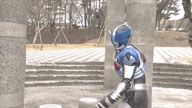 a man in a superhero costume is standing in front of a staircase