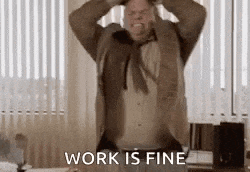 a man in a suit and tie is holding his head and screaming in an office .