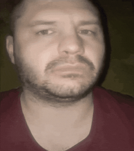 a man with a beard wearing a red shirt