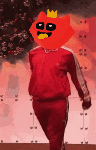 a red cartoon character with a crown on his head is walking in front of a christmas tree