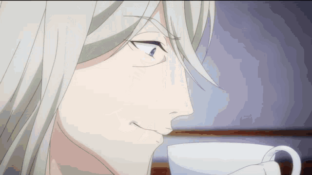 a man with white hair is drinking from a cup