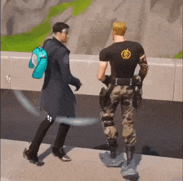 two men are standing next to each other on a sidewalk .
