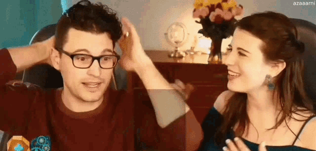 a man and a woman are looking at each other and laughing .
