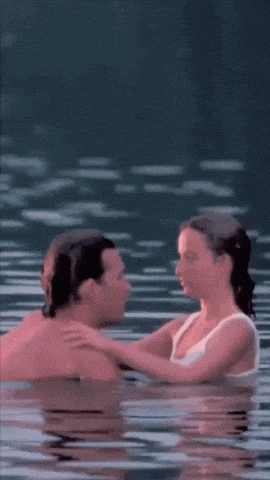 a man and a woman are swimming in the water
