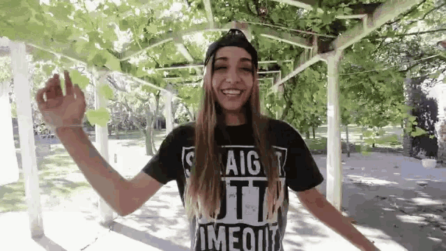 a girl wearing a black t-shirt that says ' aig ' on it