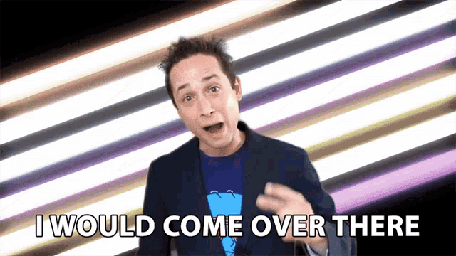 a man says " i would come over there " in front of a colorful background