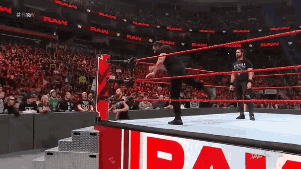 wrestlers in a wrestling ring with a banner that says raw