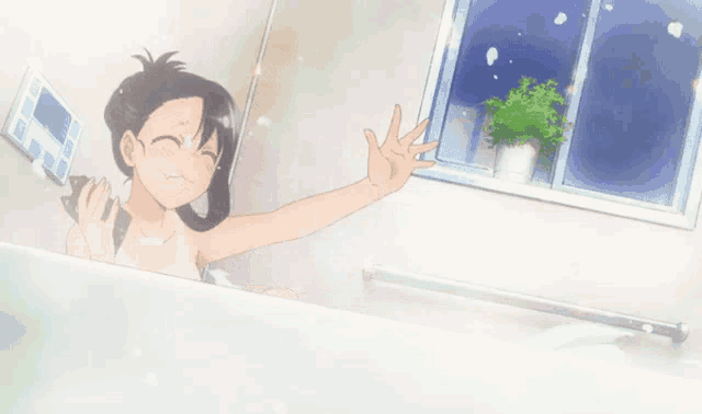 a girl is taking a bath in a bathtub and laughing
