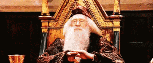 a man with a beard is sitting on a throne in a room .