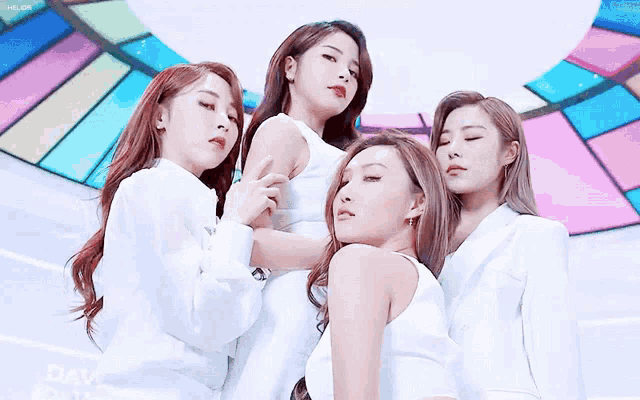 a group of young women are posing for a picture with their eyes closed