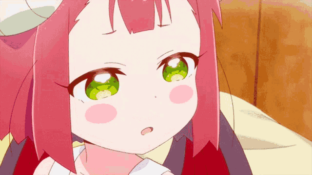 a girl with pink hair has green eyes