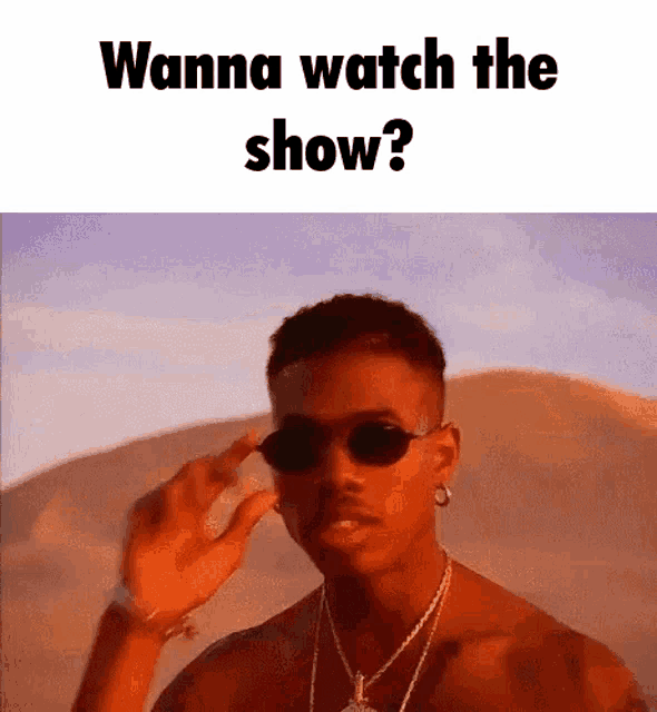 a man wearing sunglasses and a necklace is asking if he wanna watch the show .