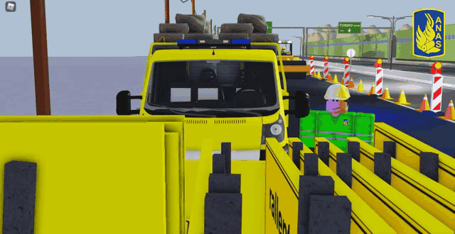 a yellow truck with the number 7 on the side is driving down a road