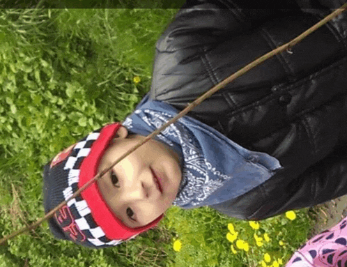 a little boy wearing a hat that says sr on it