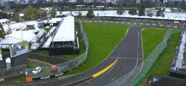 an aerial view of a race track with a sign that says #ausgp