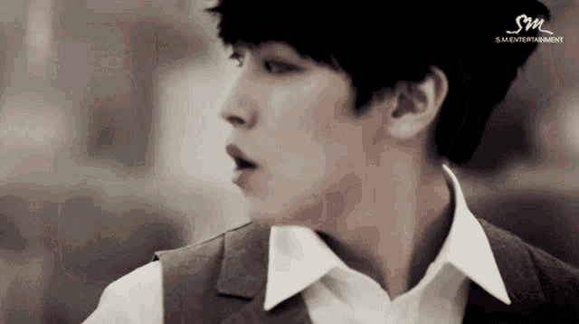 a close up of a man 's face with sm entertainment written in the corner