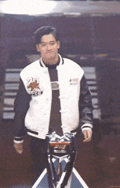 a man wearing a varsity jacket with the number 23 on it