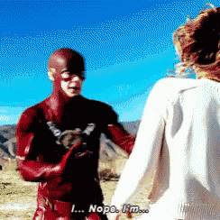 a man in a superhero costume is holding a woman 's hand and saying nope i 'm