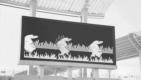 a black and white billboard with rabbits and flames on it