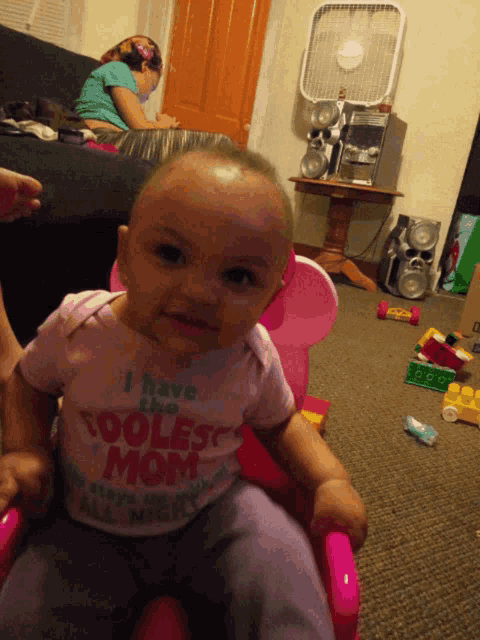 a baby with a shirt that says i have the coolest mom