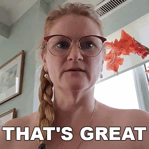 a woman wearing glasses says that 's great in front of a window