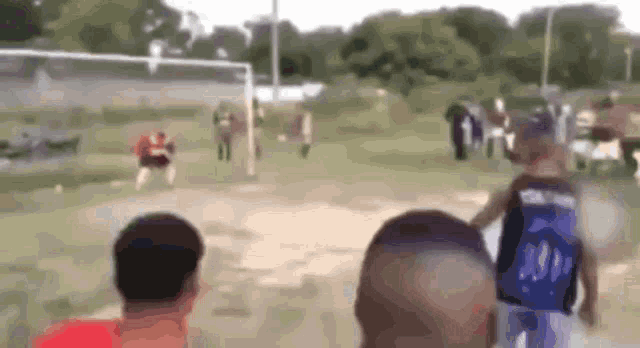a blurry picture of a soccer game with a player wearing a jersey that says ' oklahoma ' on the back