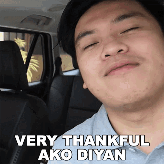 a man in a car with his eyes closed says very thankful ako diyan