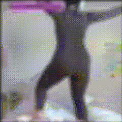 a blurry picture of a person in a black suit standing on a bed .