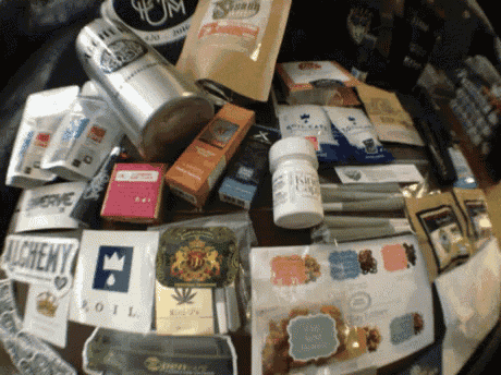 a table full of various items including a bottle of alchemy