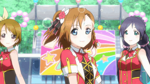 three anime girls are standing in front of a rainbow colored banner