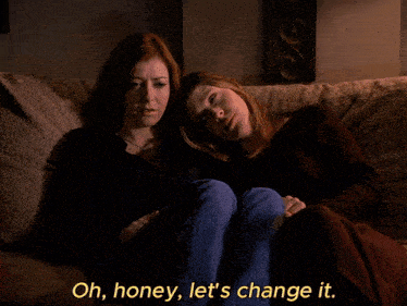 two women are sitting on a couch with the discovery channel has koala bears