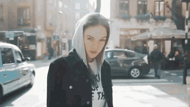 a woman wearing a hoodie and a t-shirt that says ' i 'm upset ' on it