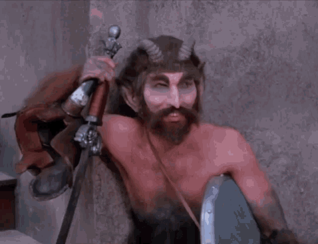 a man with horns and a beard is holding a sword