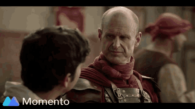 a man in armor is talking to another man with the words momento below him