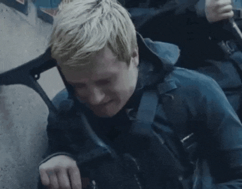 a man is sitting on a chair with a backpack on his back and smiling .