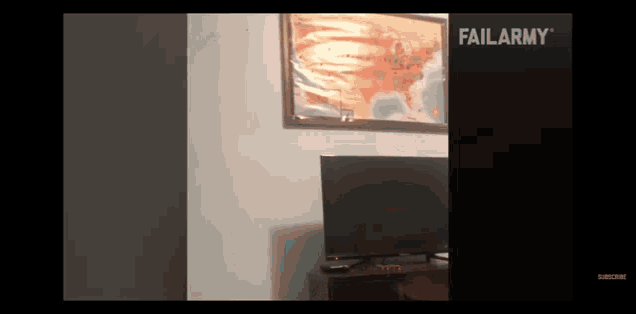 a failarmy video shows a tv and a map on the wall
