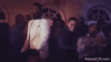 a blurred image of a crowd of people dancing with the website makeagif.com in the lower right corner