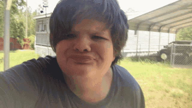 a person making a funny face in front of a trailer