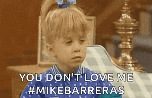 a little girl is sitting on a couch and saying `` you don t love me '' .